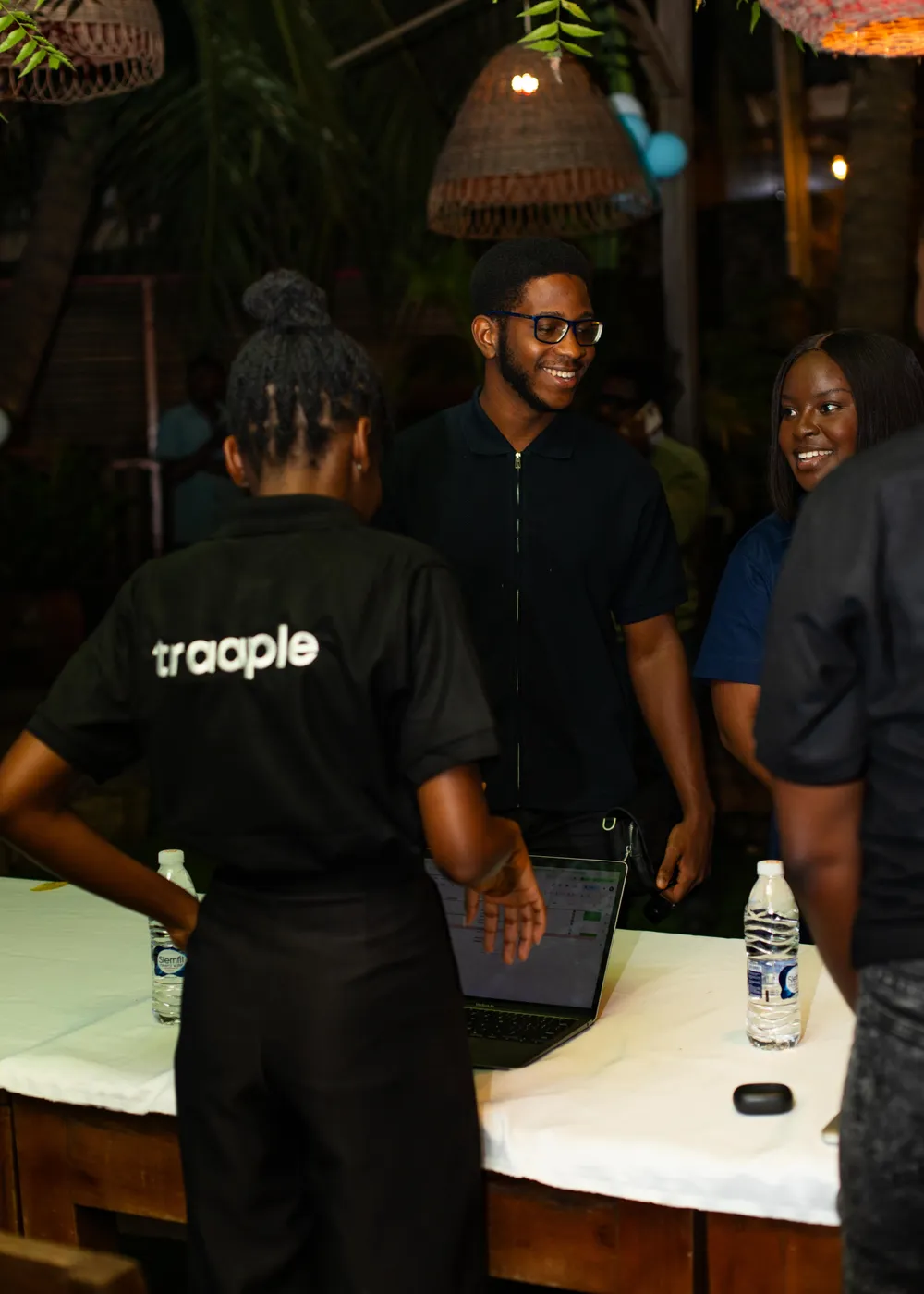 Traaple hosts serving guests at a bar counter